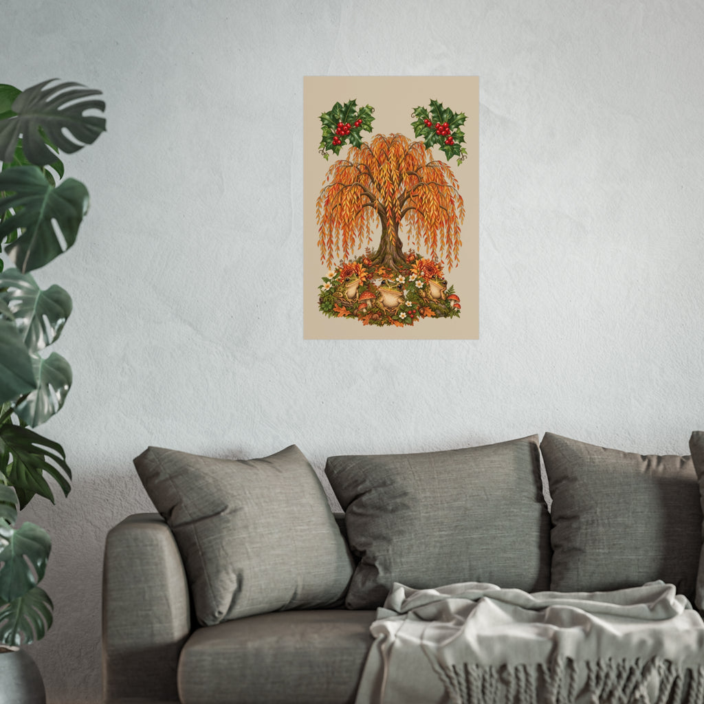 A vertical wall art print featuring an autumn tree with orange and gold leaves, surrounded by fallen leaves and two holly branches with red berries, displayed on a light gray wall above a gray sofa with a throw blanket and a potted plant in the foreground.