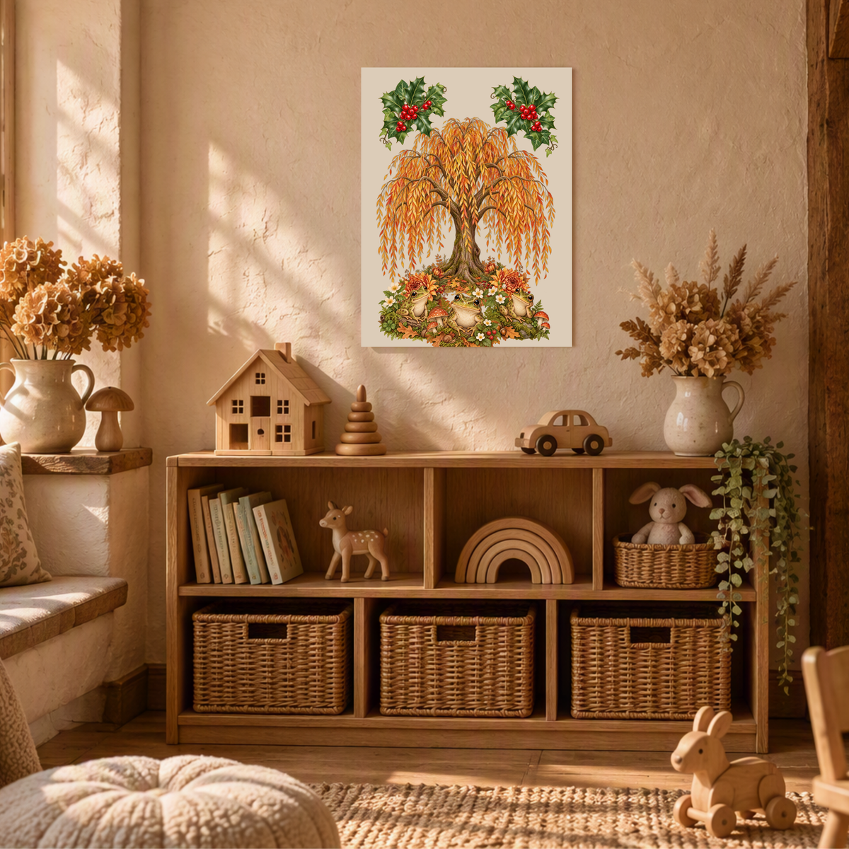 A framed wall art print featuring a stylized golden weeping tree with red berries hangs above a wooden toy cabinet in a warm, sunlit nursery or playroom. The room includes woven baskets, books, small toys, dried flowers, and soft natural lighting.