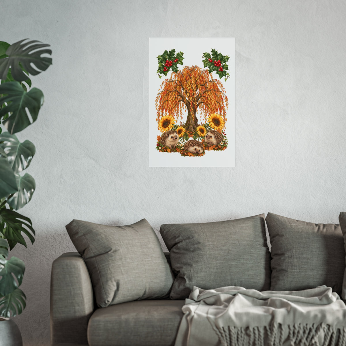 A framed wall art print featuring an autumn tree with orange leaves, sunflowers, and red berries, displayed above a gray sofa in a living room setting.