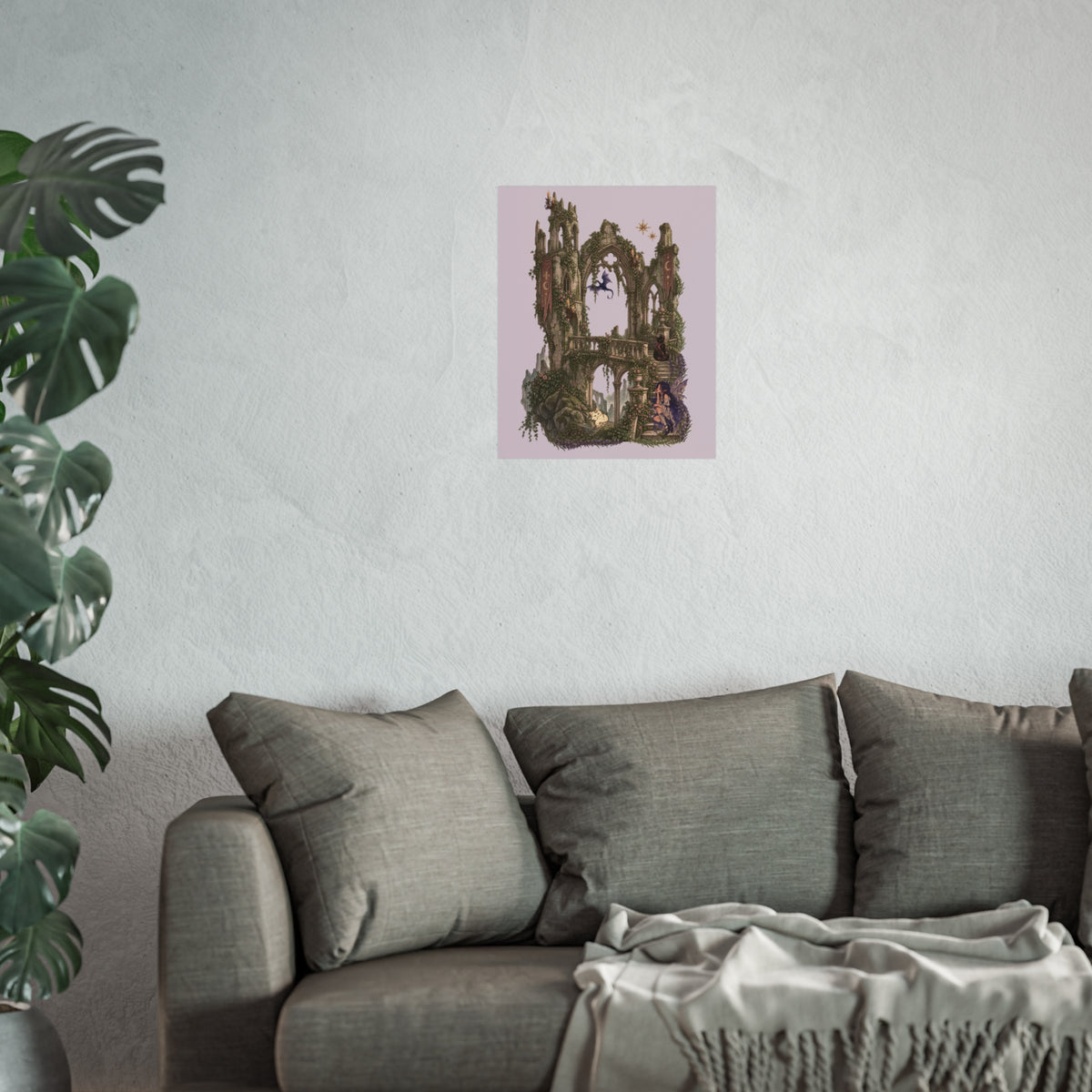 A framed wall art print featuring a surreal, moss-covered stone archway with a figure and small birds, displayed on a textured light gray wall above a gray sofa with a throw blanket and a potted plant on the left.
