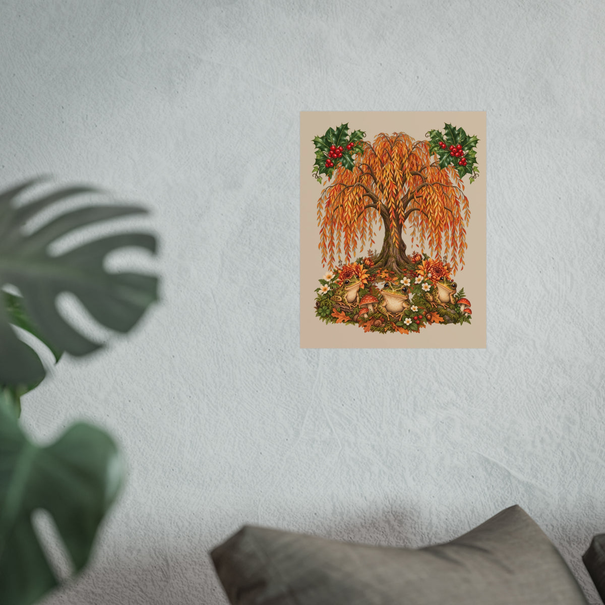 A vertical art print featuring an autumn weeping tree with orange and gold leaves, red berries, and a floral base, displayed on a textured light gray wall with a blurred green plant in the foreground.