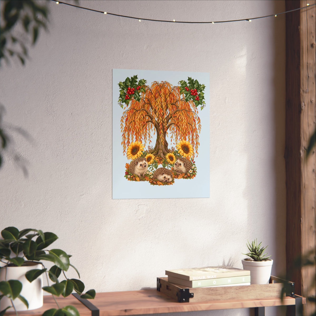 A framed wall art print featuring a stylized autumn tree with orange leaves, sunflowers, and red berries, displayed above a gray sofa in a living room setting with a plant on the left.