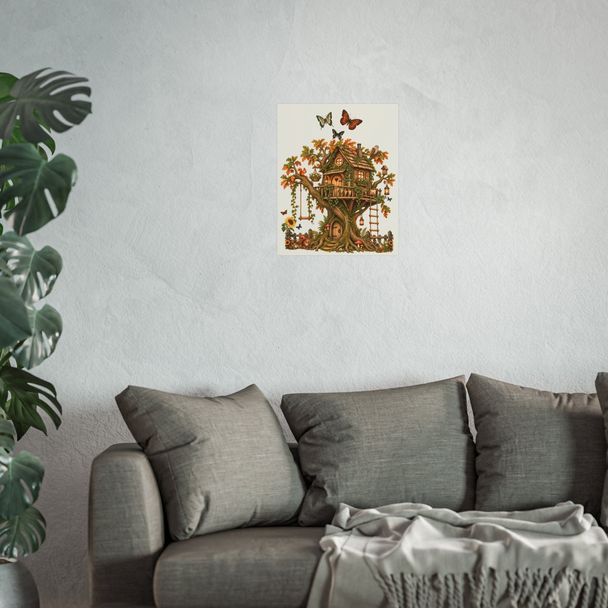 A framed wall art print featuring a whimsical treehouse illustration with butterflies, displayed above a gray sofa in a modern living room setting with a potted plant.