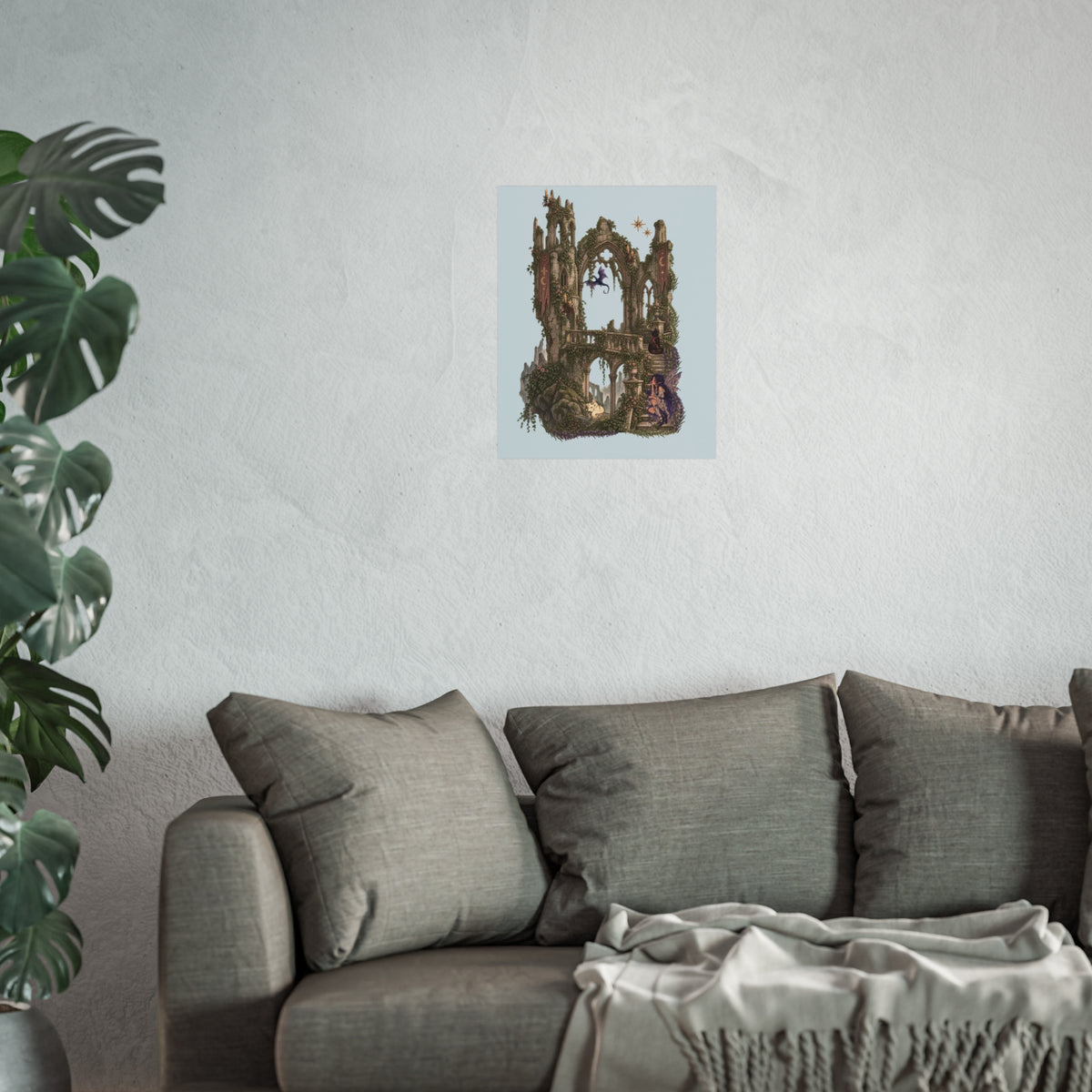 A framed or mounted wall art print featuring a surreal, abstract architectural scene with brown and gold forms against a pale blue background, displayed above a gray sofa in a styled interior with a plant on the left.